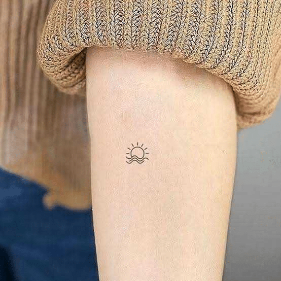 Minimalist Sunset Tattoo on forearm