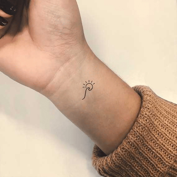 Minimalist Sunset Tattoo on wrist
