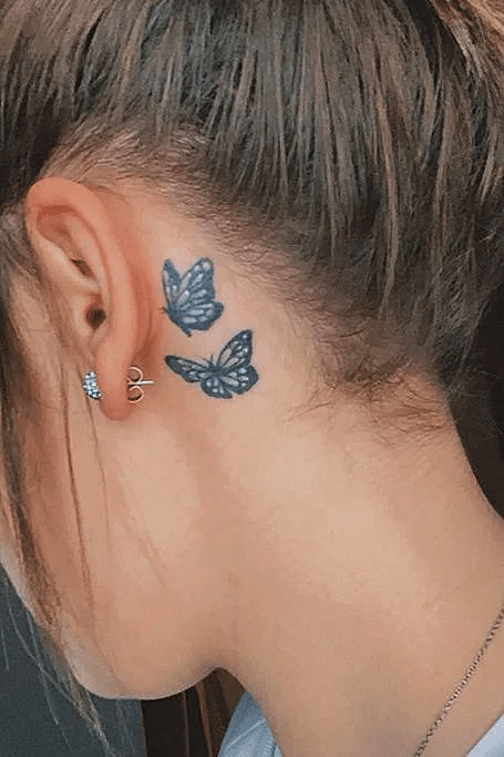corlorful butterfly tattoo behind ears