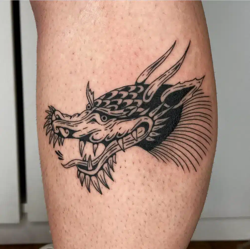 Black outline dragon head tattoo