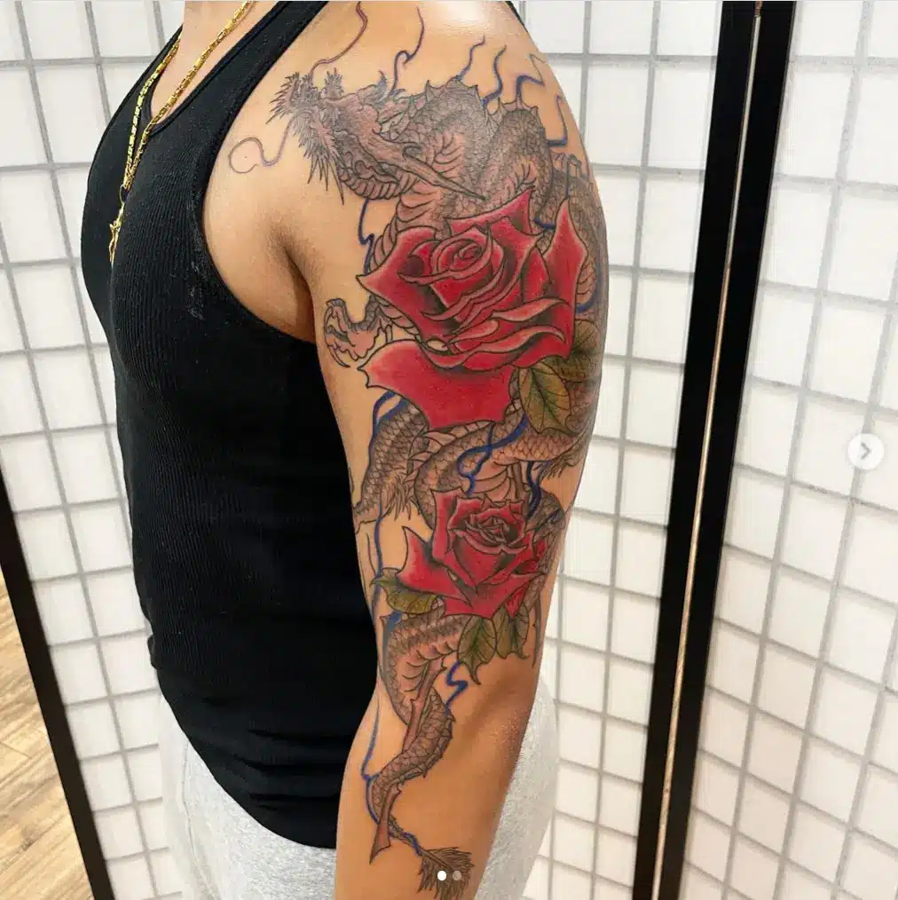 Full arm length dragon rose tattoo