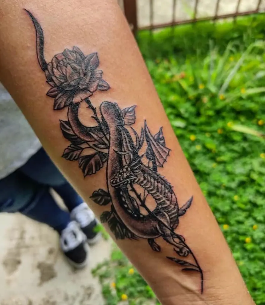 Small black dragon tattoo with rose