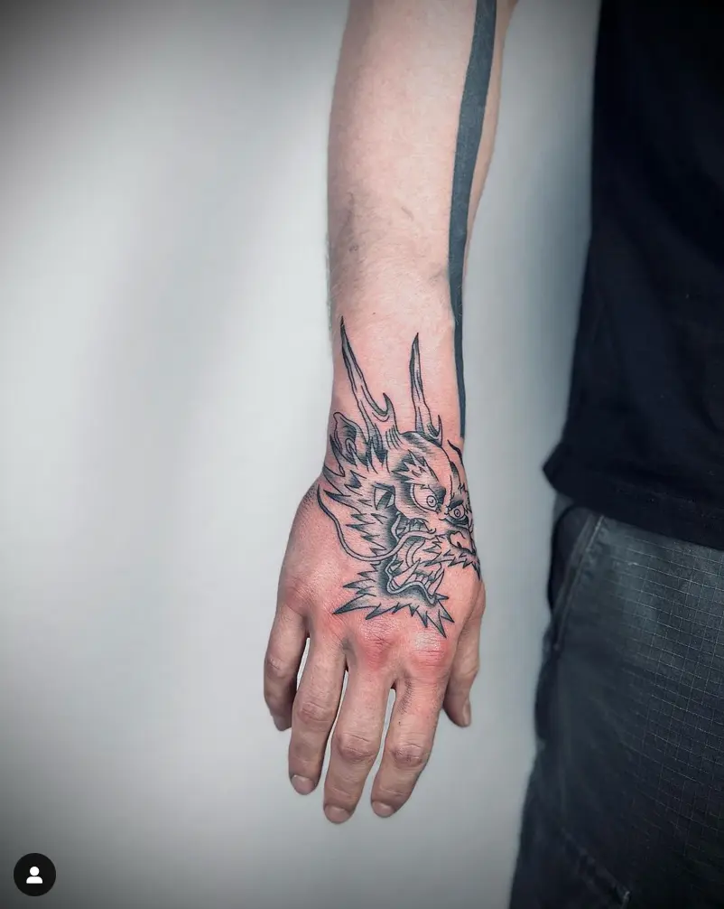 dragon head tattoo on arm