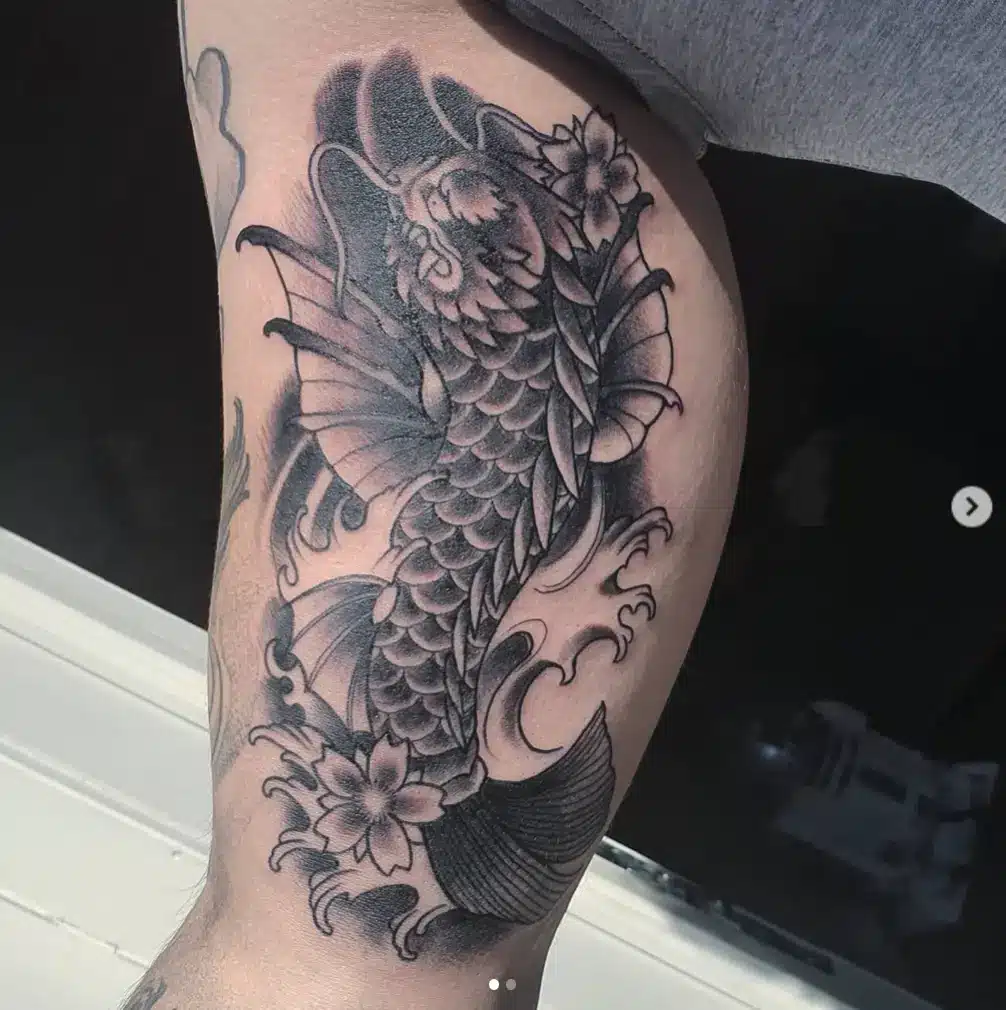 fish dragon tattoo on arm