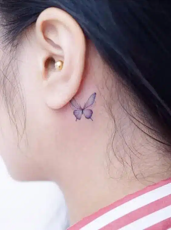 purple butterfly tattoo behind ear