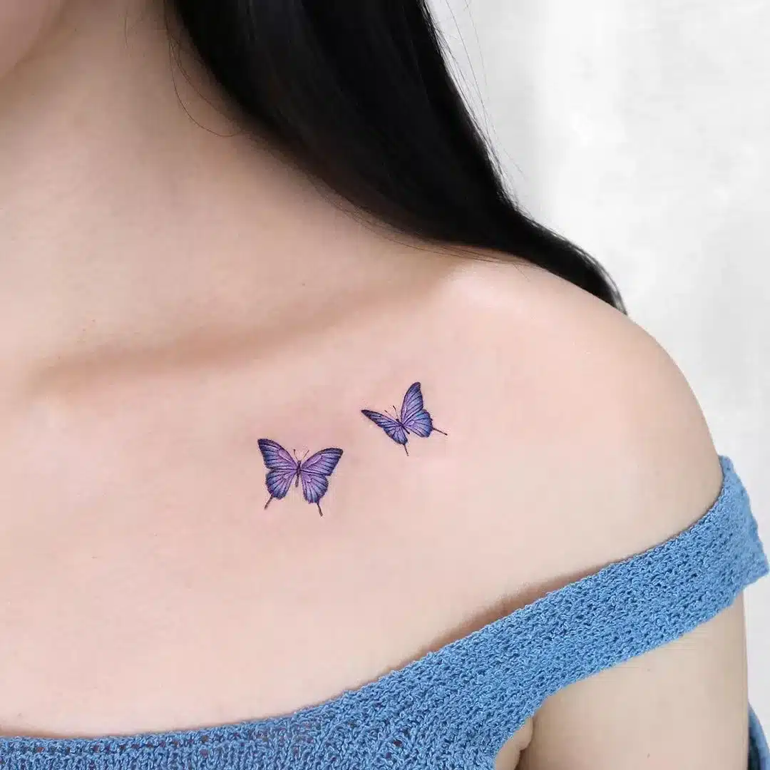 purple butterfly tattoo on Collarbone