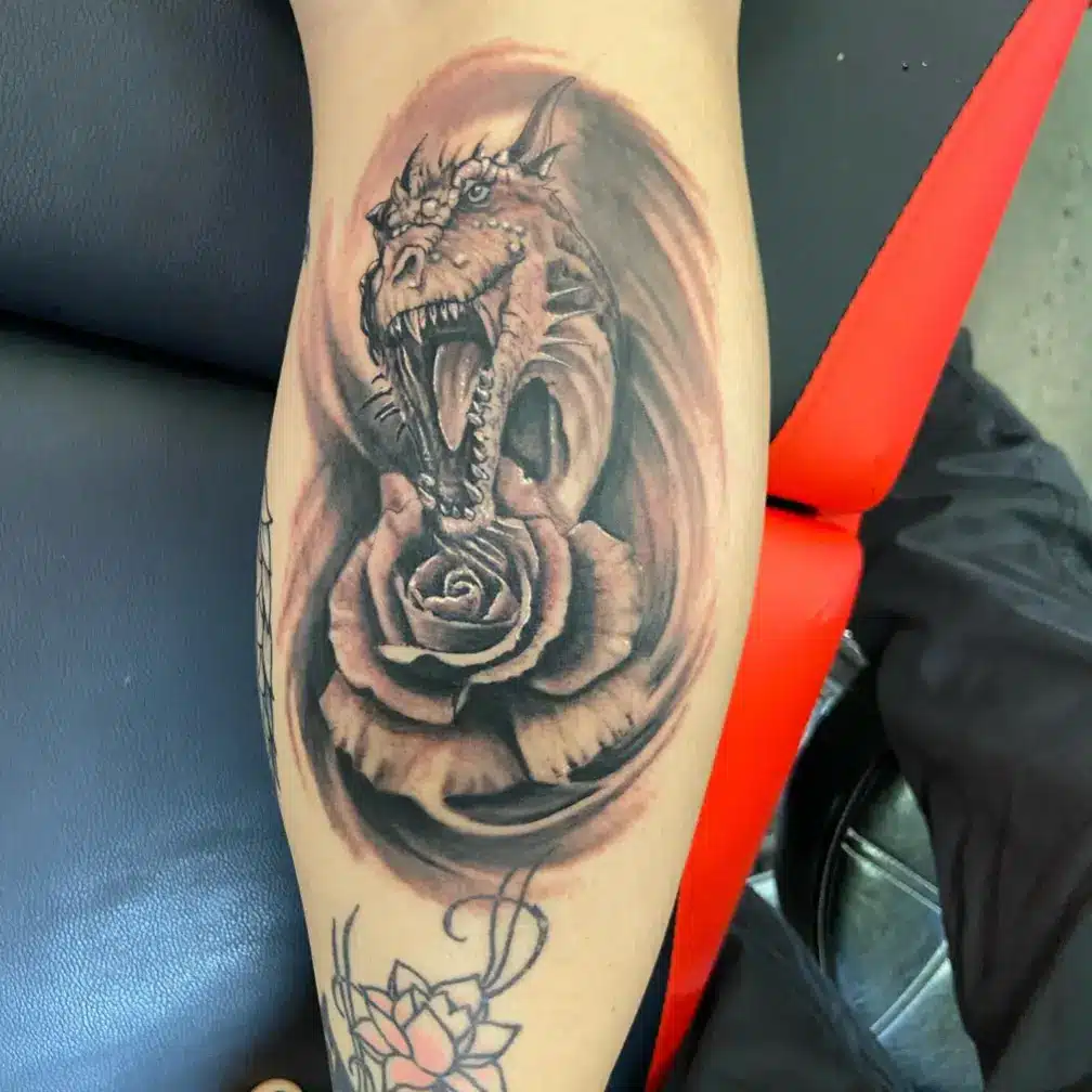 rose dragon tattoo on leg