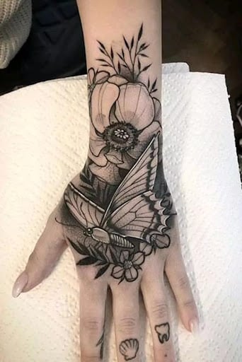 lily and butterfly tattoo on Wrist