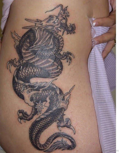 Black dragon tattoo on the thigh