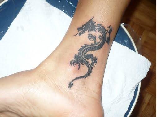 tribal dragon tattoo on ankle