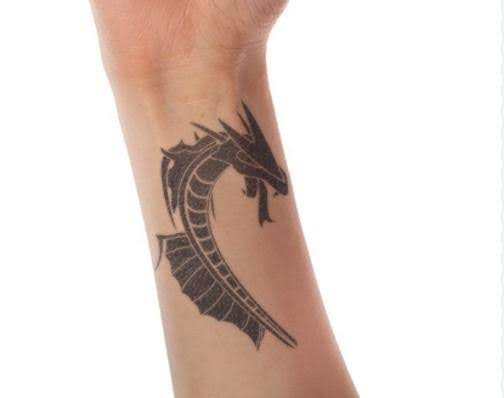 tribal dragon tattoo on wrist