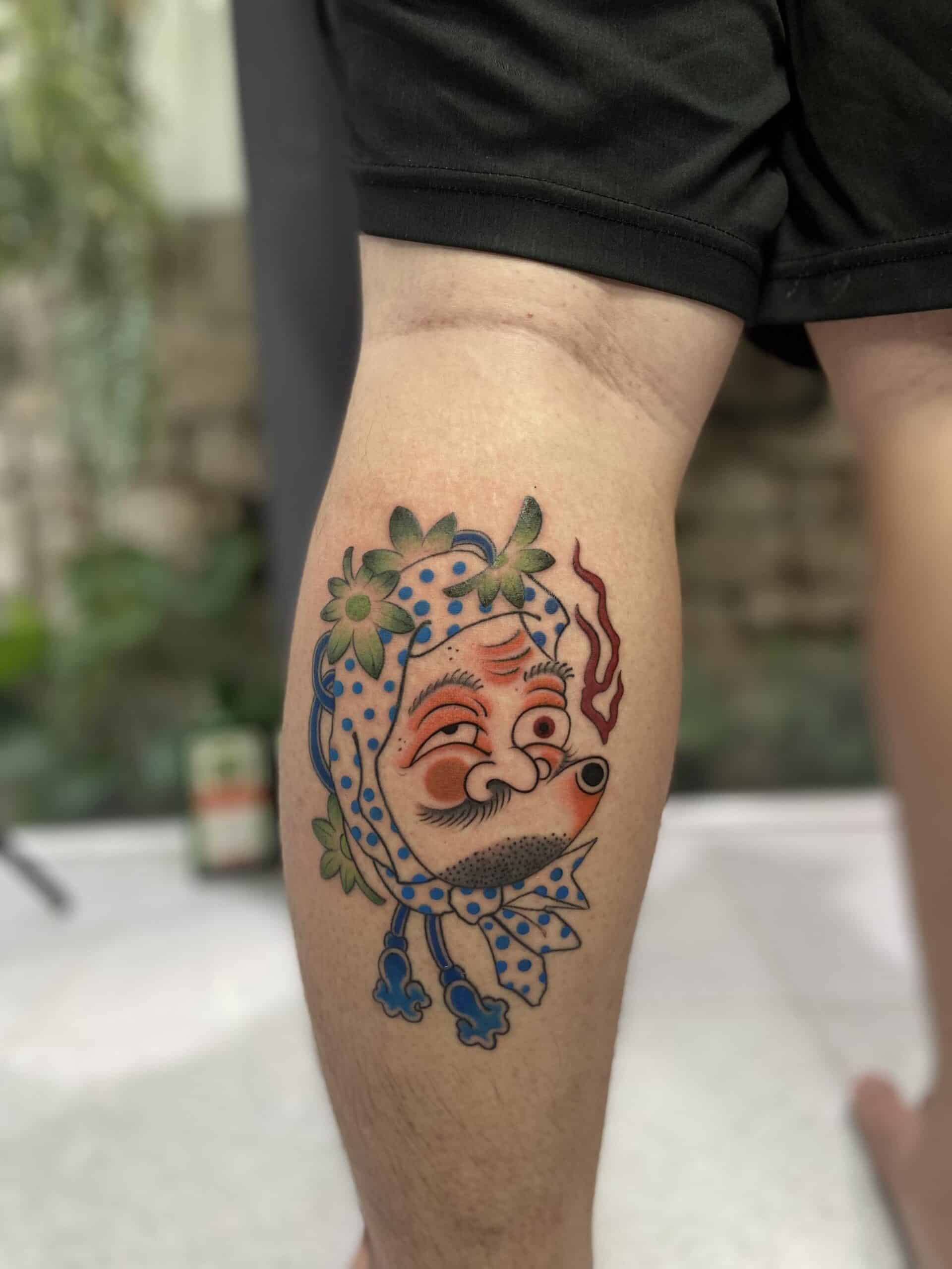 Japanese Mask Tattoo On Leg