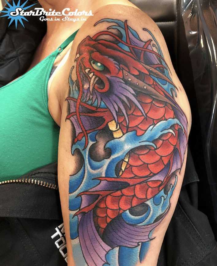 Dragon Fish Tattoo On The Arm