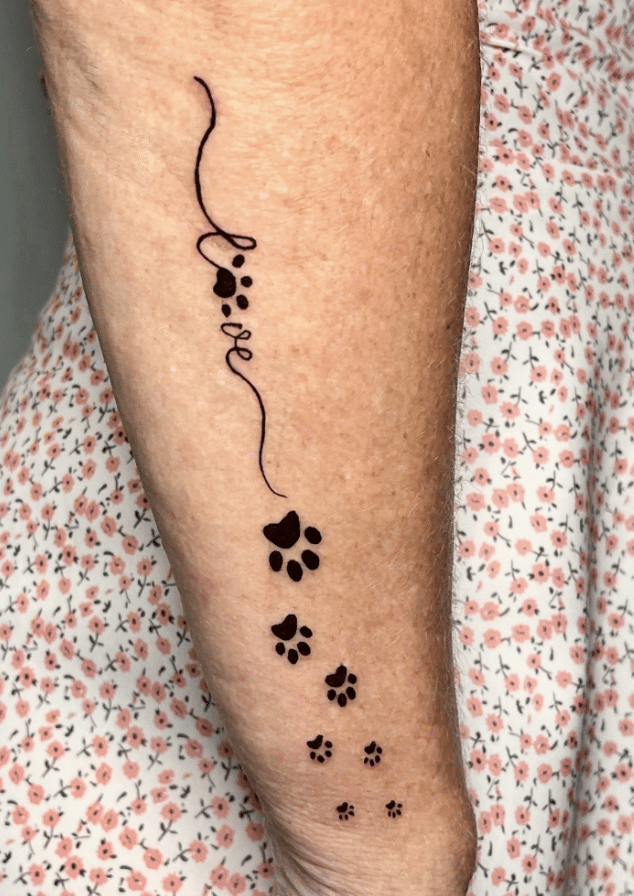Writing And Paw Print Tattoo